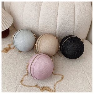 Detail view of sparkly spherical evening clutch bags in silver, gold, black and pink colors