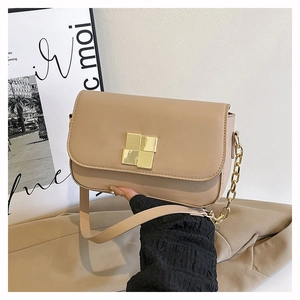 Detail view of khaki PU leather bag featuring a gold square buckle and chain strap