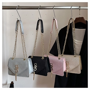 Detail of glitter chain bags in silver, black, pink and gold with tassels and metal logos