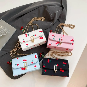 Sweet cherry print crossbody bags with gold chains in white, pink, blue, and black