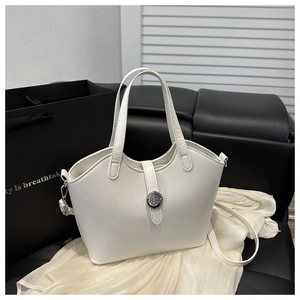 Close-up of white bucket bag with silver metal buckle and adjustable shoulder strap