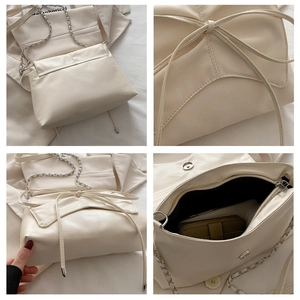 Détail du sac à bandoulière crème avec cordon noeud et bandoulière chaîne argent