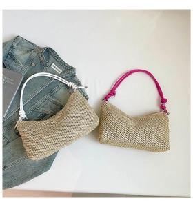 Detail of hand-woven straw tote bags with cotton rope knots on a denim background