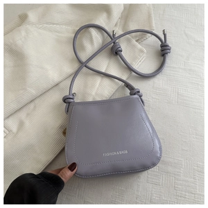 Detailed macro view of a lavender purple shoulder bag with silver Fashion & Bags text