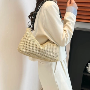 Chic beige woven straw hobo tote bag with black shoulder strap and knot detail