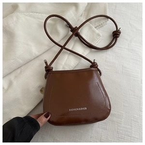 Detailed macro view of a vintage brown saddle bag with fashion engraving and fine texture