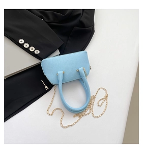 Top view of light blue lychee pattern mini shell bag with golden chain and round handles
