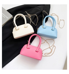 Three lychee-textured mini crossbody shell bags in white, blue, and pink colors