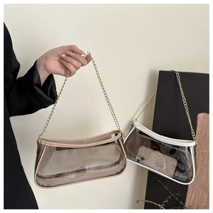 Detail of transparent PVC shoulder bags with gold chain straps showing internal capacity