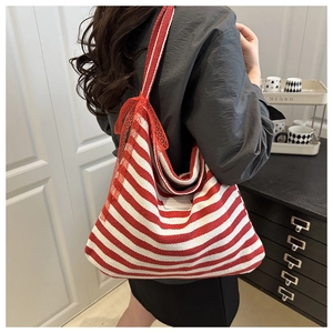 Detail of red and white striped canvas tote with lace straps and side label decoration