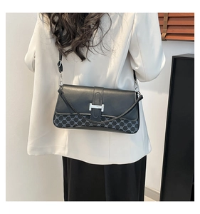 Black leather and jacquard crossbody bag with silver H-buckle worn by a model