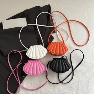 Mini shell-shaped crossbody bags in four colors with textured synthetic leather finish