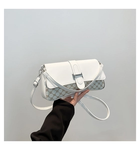 Detail of white leather and monogram canvas crossbody bag with silver metallic clasp