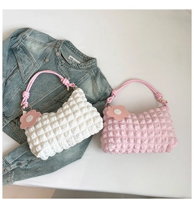 Detail of ruched bubble texture fabric on crossbody bags with cute floral charms