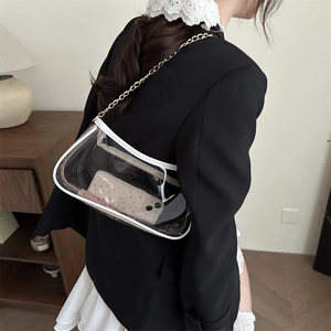 Minimalist transparent PVC baguette bag with white trim and golden chain strap on model