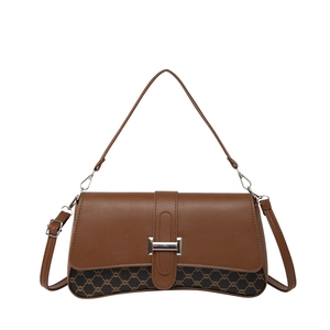 Vintage brown leather crossbody bag with retro monogram canvas detail and silver buckle