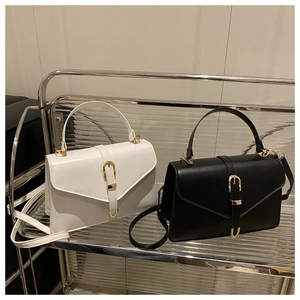 Detailed view of the smooth leather square handbag with metal buckle and top handle