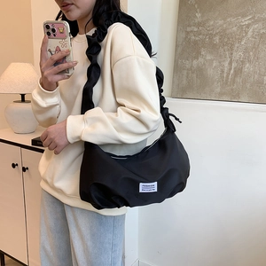 Chic black pleated hobo bag with ruffle strap and minimalist patch detail for women