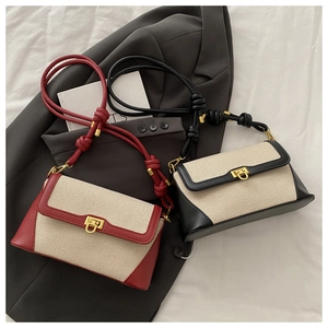 Flat lay of canvas patchwork shoulder bags in burgundy and black with gold locks