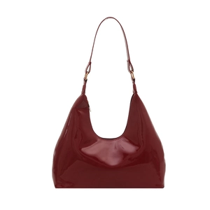 Glossy burgundy patent leather crescent shoulder bag with elegant minimalist design