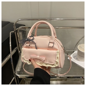 Detailed shot of pink lace handbag with bow and checkered ribbon in hand