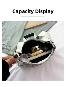 Internal capacity of the white bag showing storage for phone, lipstick, and cosmetics