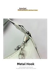 Detailed close-up of the metal hooks and butterfly chain hardware on white quilted bag