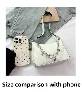 Detailed view of white quilted shoulder bag with silver butterfly chain and size reference