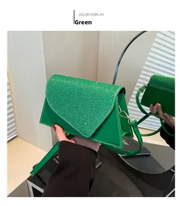 Detail of green crossbody bag showing glitter flap texture and white contrast stitching