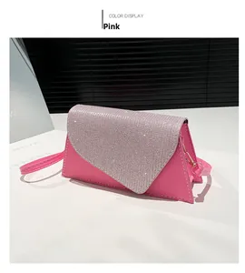 Detail of pink asymmetric crossbody bag with glitter flap and contrast stitching