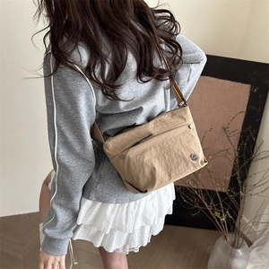 Japanese style khaki canvas crossbody messenger bag for men and women on a model