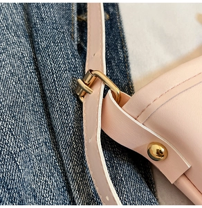 Macro detail of pink PU leather tote with gold ring buckles and precise stitching