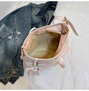 Spacious interior of light pink tote bag with zip closure and cream lining detail