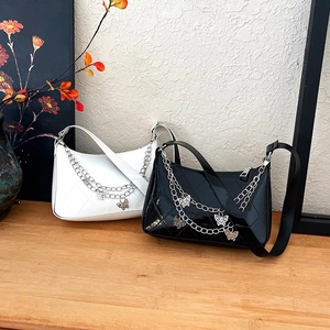 Quilted butterfly chain baguette bag in black and white glossy faux leather finish