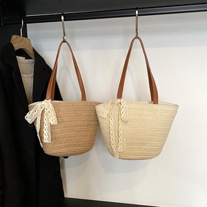 Large straw bucket bags in dark brown and beige with lace bows for summer beach vacations