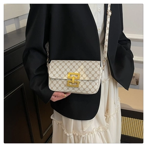 Close-up of vintage print crossbody bag with gold geometric clasp and PU leather