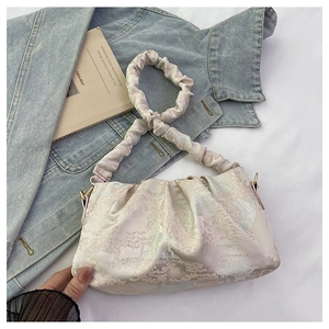 Detail of light pink pleated cloud bag with jacquard pattern and metallic sheen