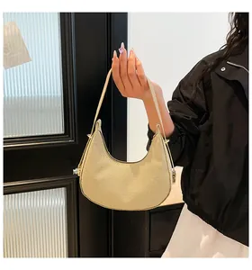 Detail view of champagne gold hobo bag with textured finish and curved handle design
