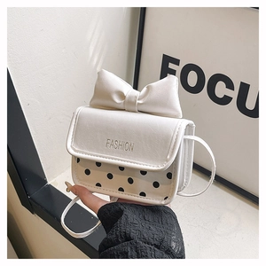 Close-up of bow knot decoration and black polka dot pattern on white small square bag
