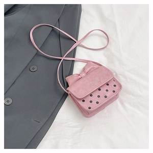 Detail of pink bow handbag with black polka dots and silver Fashion lettering