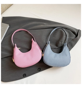 Detail of pink and blue hobo bags showing high-quality textured twill fabric and sleek curves