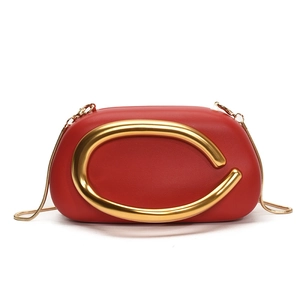 Luxurious red leather shoulder bag with bold gold C-shaped metal handle and chain strap