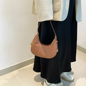Brown woven half-moon hobo bag with adjustable shoulder strap and gold-tone hardware