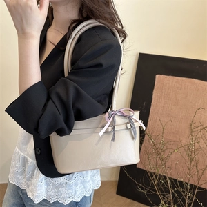 Chic beige faux leather underarm bag for women with decorative double bow and dual handles