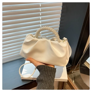 White ruched cloud bag featuring elegant pearl bead handle and slim crossbody strap