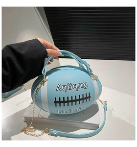 Detail of light blue rugby ball bag featuring litchi grain PU leather and gold chains