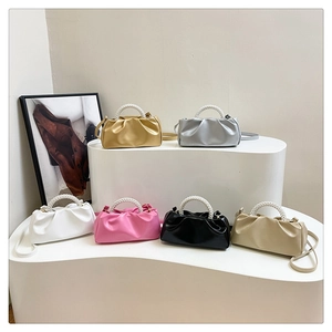 Collection of pleated pearl handle mini bags in gold silver white pink black and beige
