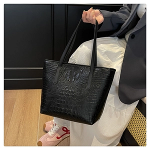 Close-up of black crocodile pattern faux leather texture on the large tote bag