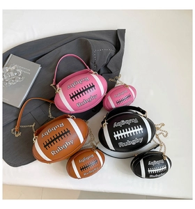 Three rugby-shaped crossbody bags in pink, black, and brown with gold chains