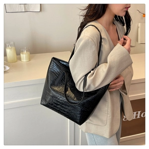 Detailed view of the black crocodile pattern texture on a large capacity tote bag